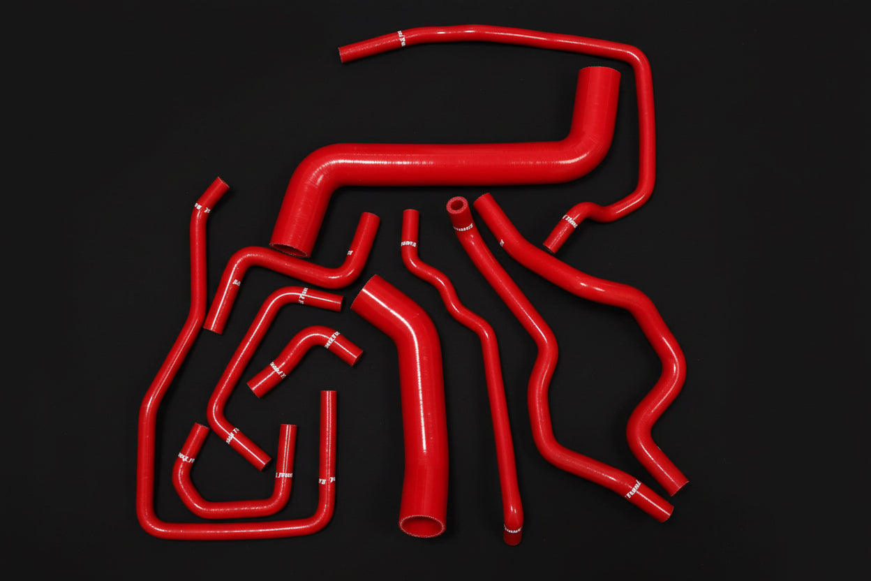 Red silicone hoses on a black background