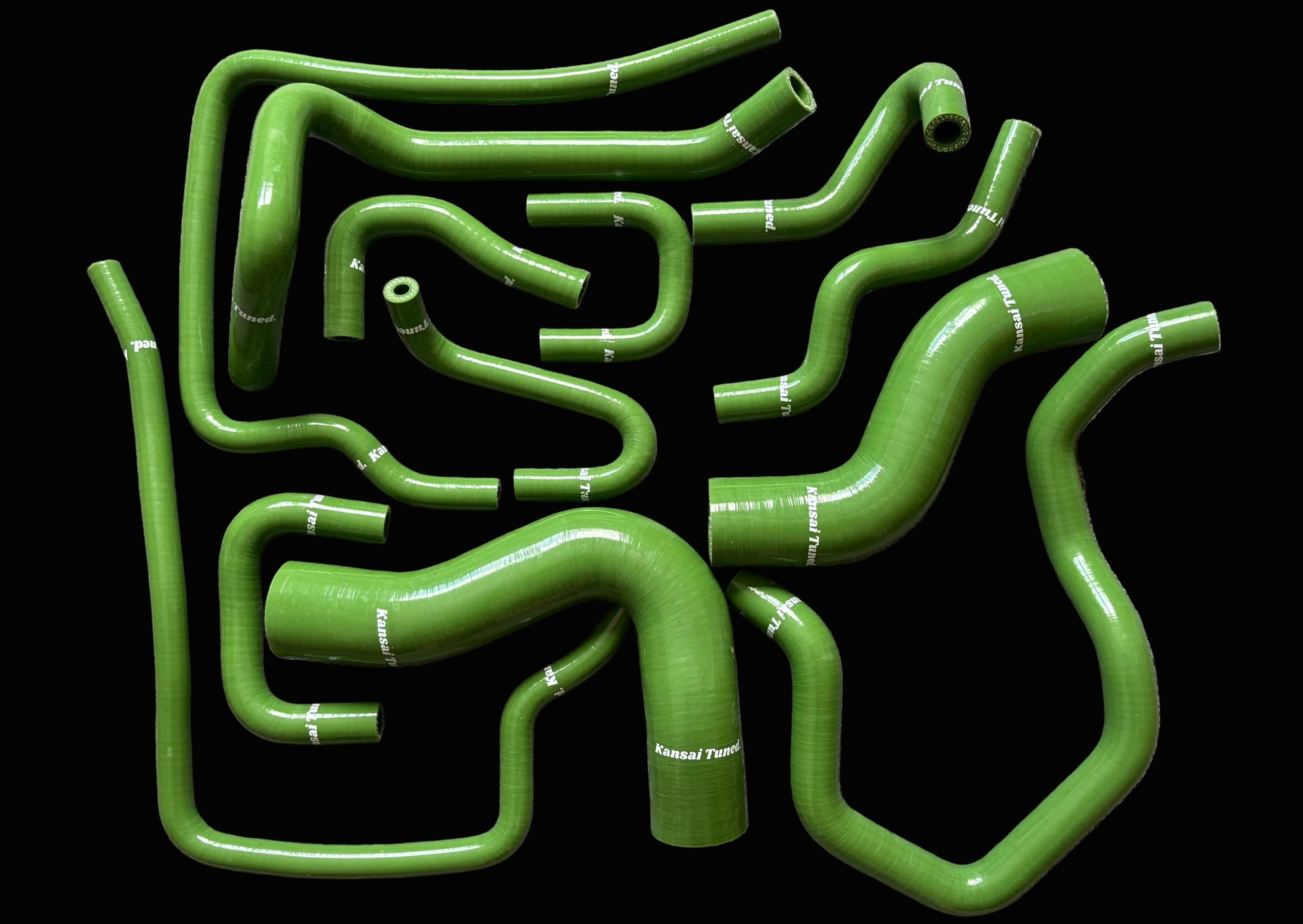 Set of green silicone hoses on a gray surface