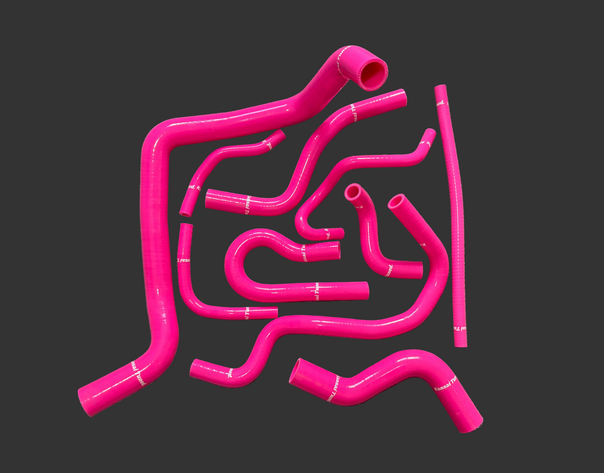 Set of pink silicone hoses on a black background