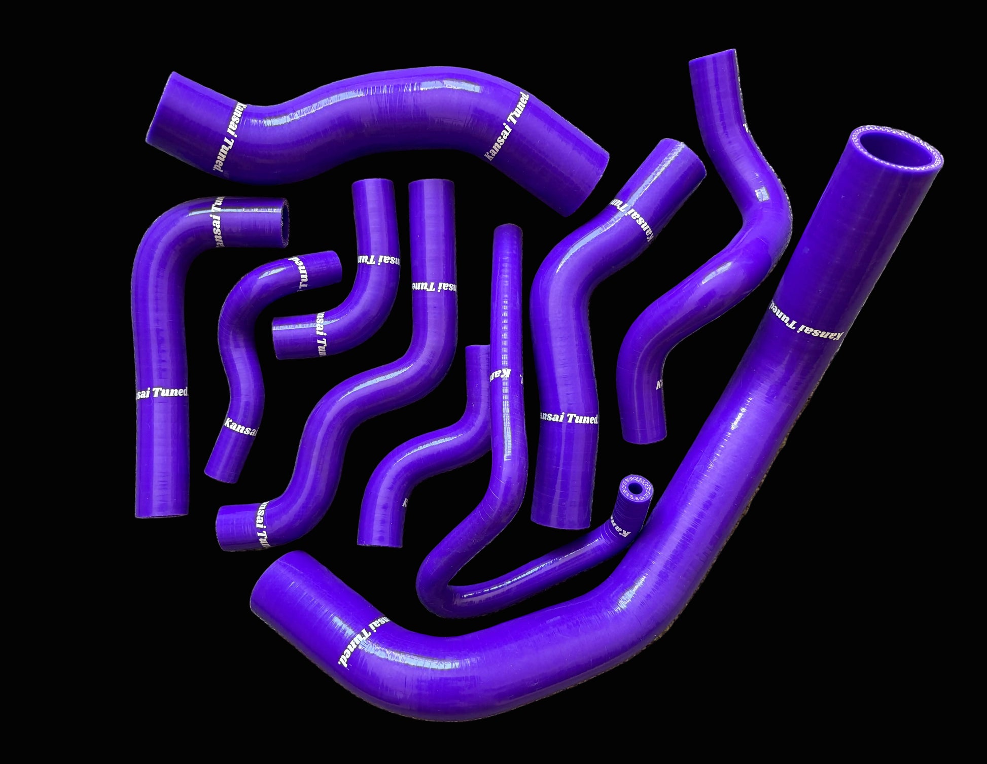 Set of purple silicone hoses on a gray surface