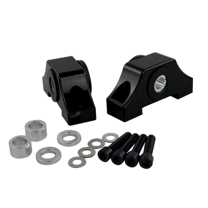 Black mechanical components with washers and bolts on a white background